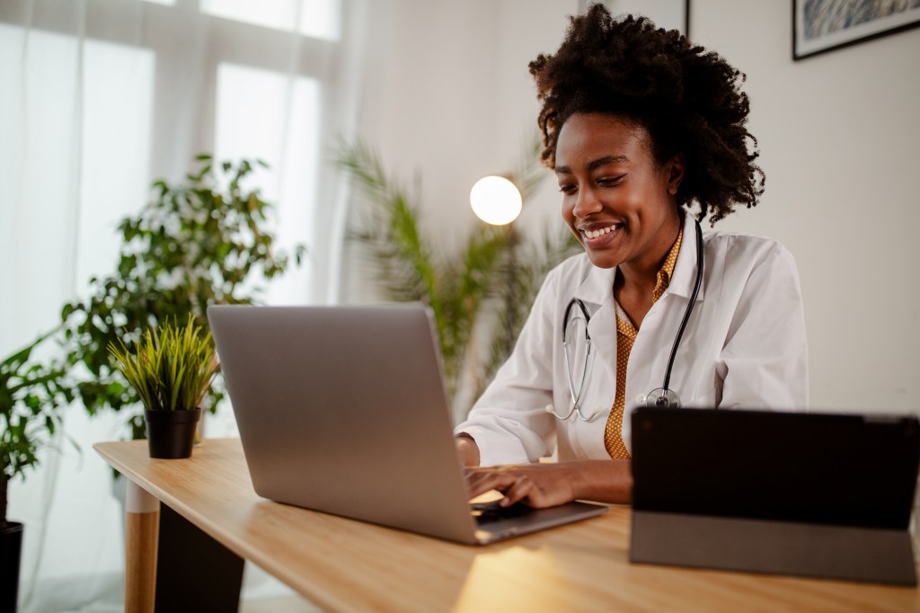 Successful,Young,Afro,American,Female,Doctor,In,White,Medical,Uniform