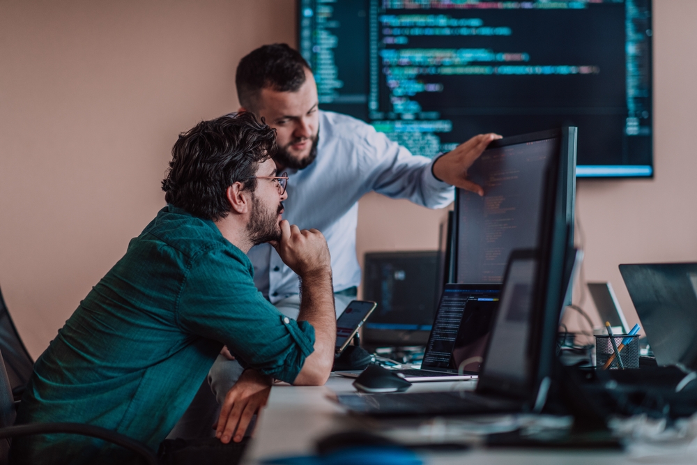 Programmers,Engrossed,In,Deep,Collaboration,,Diligently,Working,Together,To,Solve